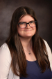 Woman with long brown hair and glasses