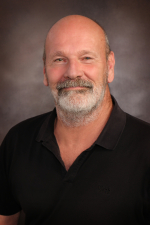 John Strefling Man with gray beard wearing a black collared shirt