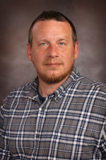 Bradley Brandon Man with light brown hair wearing a button-down plaid shirt