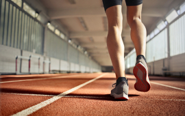 Feet in sneakers walking along an indoor path