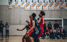 A group of men playing basketball in the gym