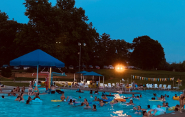 Families enjoying a movie in the pool at the Wollman Aquatic Center