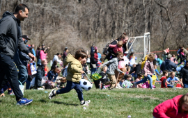 Children and their parents hunting eggs at Easter egg hunt