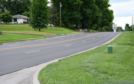 Photo of four lane road with new blacktop and striping