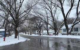 Snowy street winter street with snow on the sides of the road, road has been cleared of snow and ice