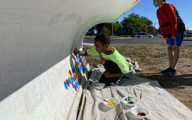 Children painted snowplows at local Leavenworth elementary schools. Boy painting on a snowplow blade