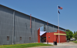 photo of large building with American and Kansas flags out front
