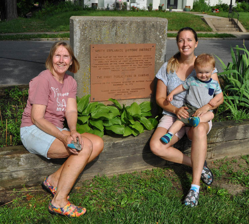 Photo of a family posed in front of the North Esplanade park sign 