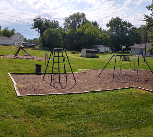 A slide, swings, and climbing equipment at Kane Park
