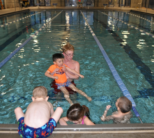 Swim Lesson with four children and instructor at Riverfront Community Center Pool