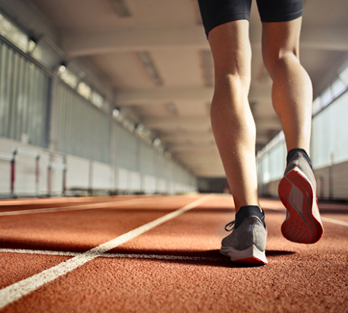 Feet in sneakers walking along an indoor path