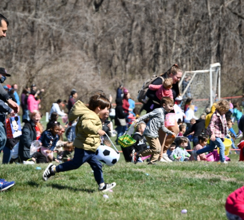 2023 Egg Hunt Children and their parents hunting eggs at Easter egg hunt