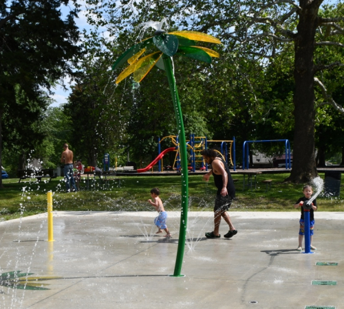 Children playing on the new splash pad in 2023