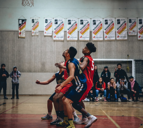 A group of men playing basketball in the gym