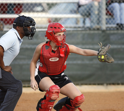 Photo of the plate umpire and the catcher playing coed softball