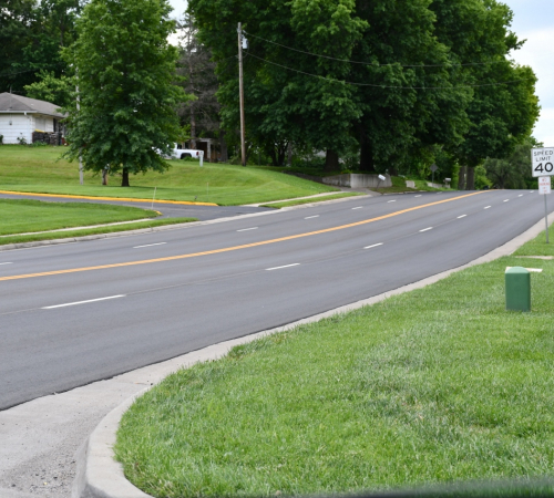 Photo of four lane road with new blacktop and striping