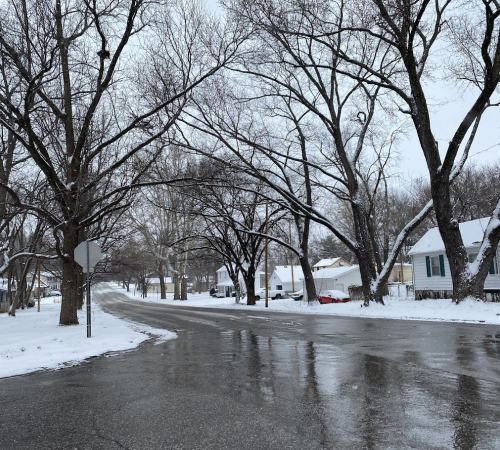 winter street with snow on the sides of the road, road has been cleared of snow and ice