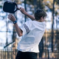 action shot of young pickleball player