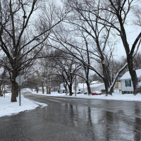 Snowy street winter street with snow on the sides of the road, road has been cleared of snow and ice