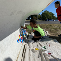 Children painted snowplows at local Leavenworth elementary schools. Boy painting on a snowplow blade