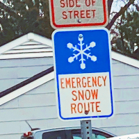 Emergency Snow Route sign with blue and white snowflake