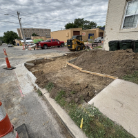 sidewalk ramp construction image of sidewalk ending where it has been removed, surrounded by cones and wooden cement molds