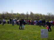 Photo of kids and adults waiting for their turn to look for Easter eggs in 2011