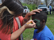 Child getting their face painted during Easter Egg Hunt