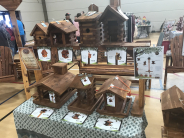 A vendor with handmade wooden bird houses to sell in 2019