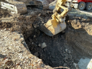 image of construction eqiupment digging large hole for adding stormwater structures