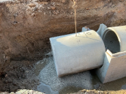 Image of large storm drain culvert going into the ground