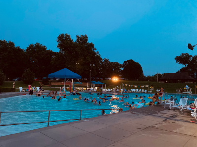 Adults in Wollman Pool watching the movie playing at the dive in 2021