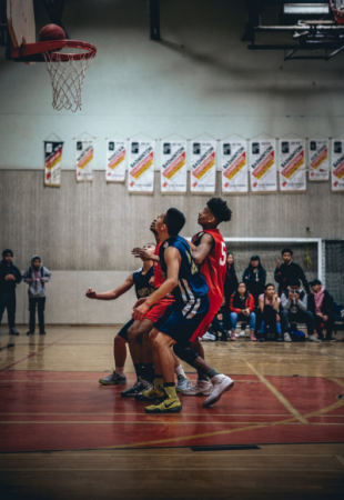 A group of men playing basketball in the gym