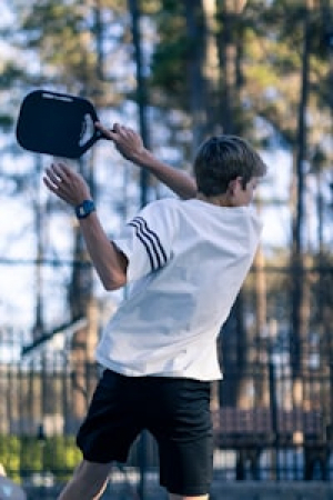 action shot of young pickleball player