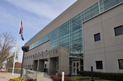 Photo of building with American flag, sign reads Justice Center