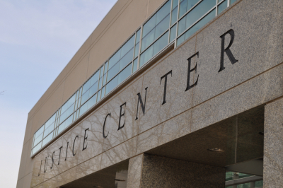 Photo of building with sign that reads Justice Center