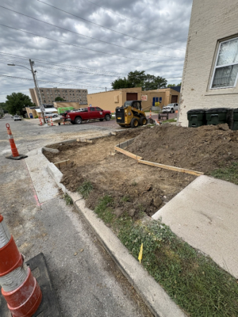 image of sidewalk ending where it has been removed, surrounded by cones and wooden cement molds