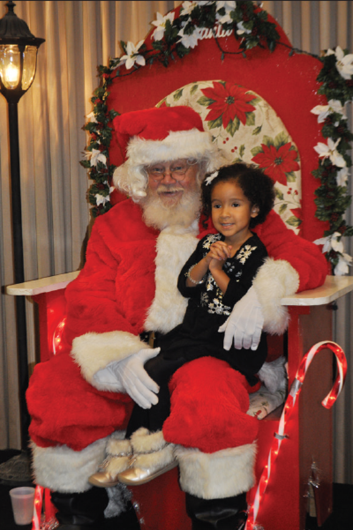A child sitting on Santa's lap at Breakfast with Santa