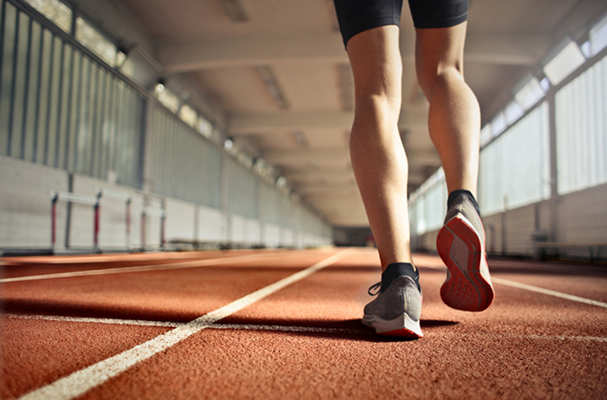 Feet in sneakers walking along an indoor path