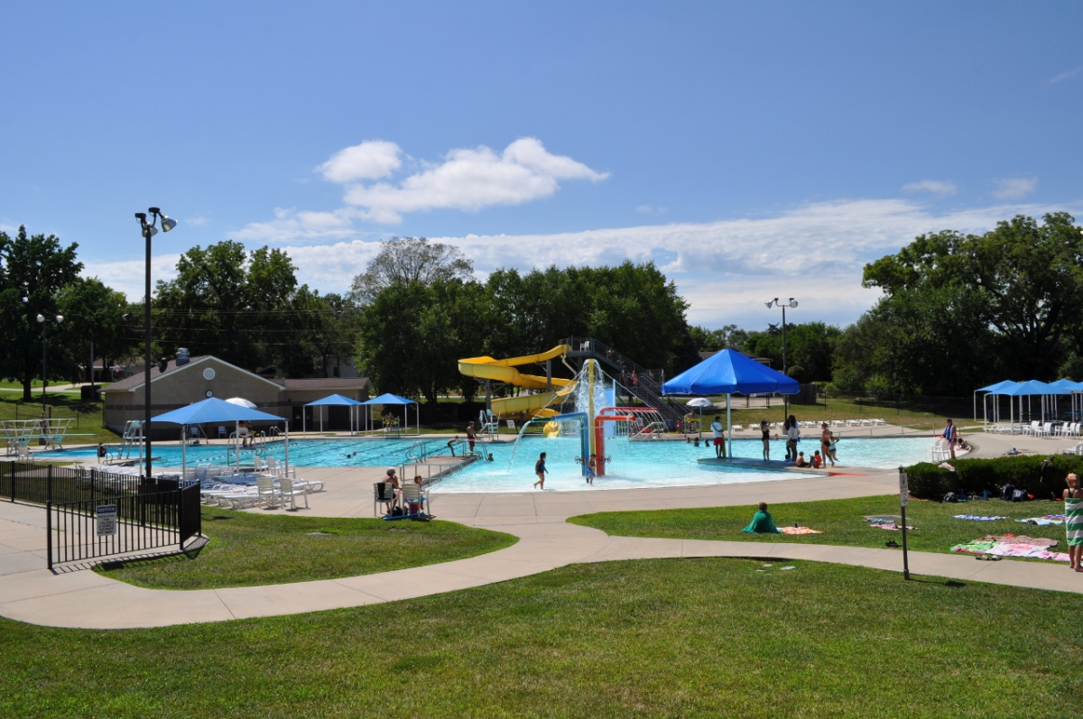 Wollman Aquatic Center photo of pool with zero depth entry surrounded by green grass and sidewalks