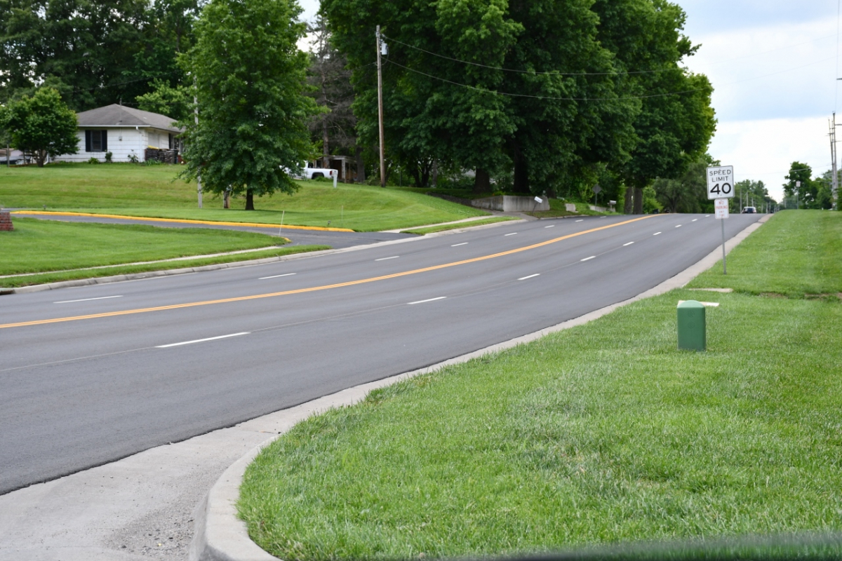 Photo of four lane road with new blacktop and striping