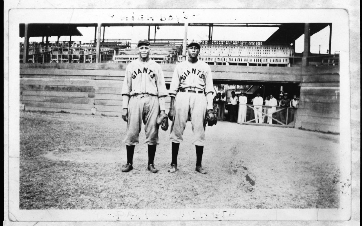 T. J. Young and Chet Arthur Brewer Two black men in Giants baseball uniforms on a baseball field