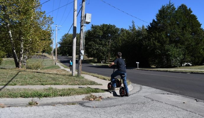 Child lifts bike over curb without ADA ramp Child lifts bike over curb without ADA ramp