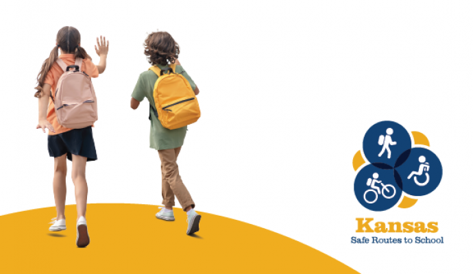 2 kids walk with packs, reads Help us make it safer to walk, bike and roll to school in Leavenworth Kansas Safe Routes to school