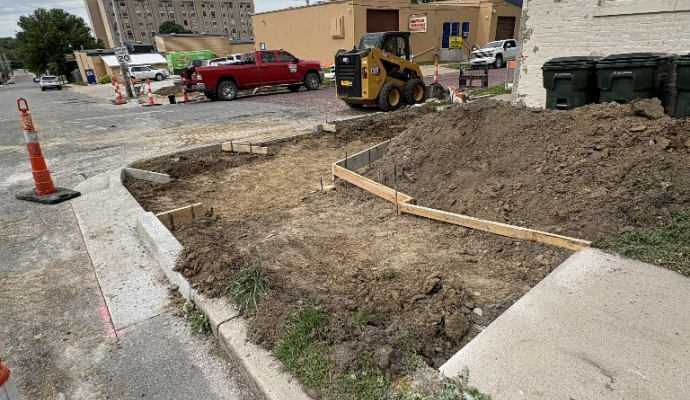 image of sidewalk ending where it has been removed, surrounded by cones and wooden cement molds