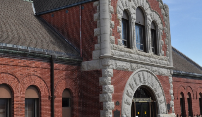 Photo of historic red brick building with limestone accent arches