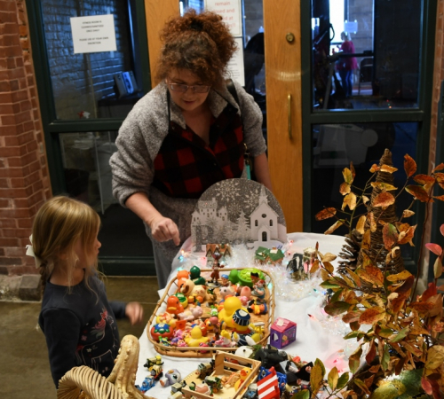 2022 Christmas in July Holiday Market Mom and daughter shop crafts at a holiday market